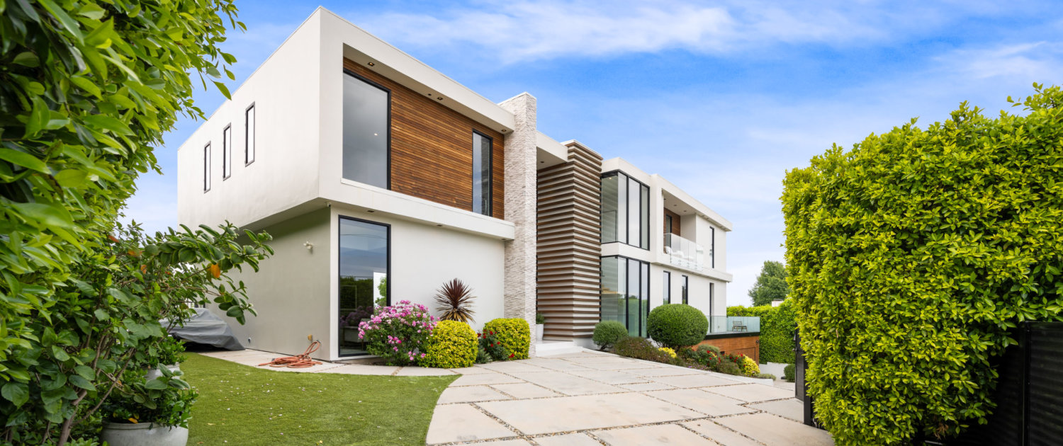 Driveway of a contemporary house with a garden area
